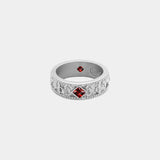 Silver ring with red gemstones on a white background