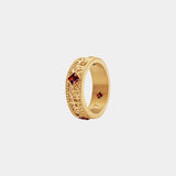 Gold ring with red gemstones on a white background
